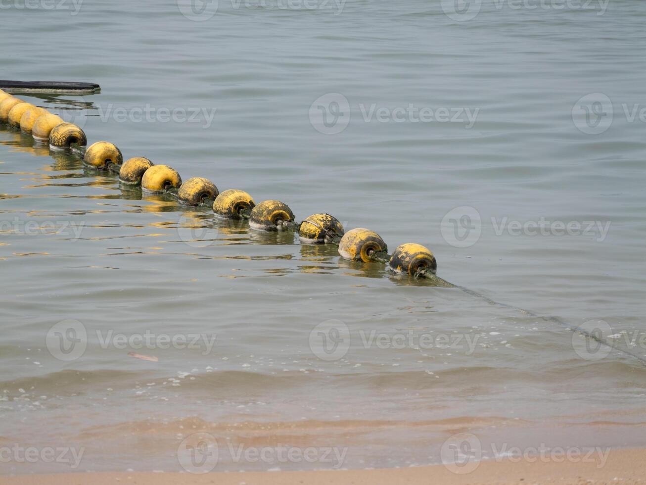Floating buoys marking shoreline safety coastal area nature scene calm waters eye-level view photo