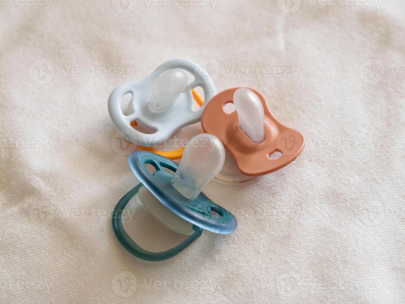 Baby pacifiers soft fabric nursery setting still life calm vibe close-up infant care photo