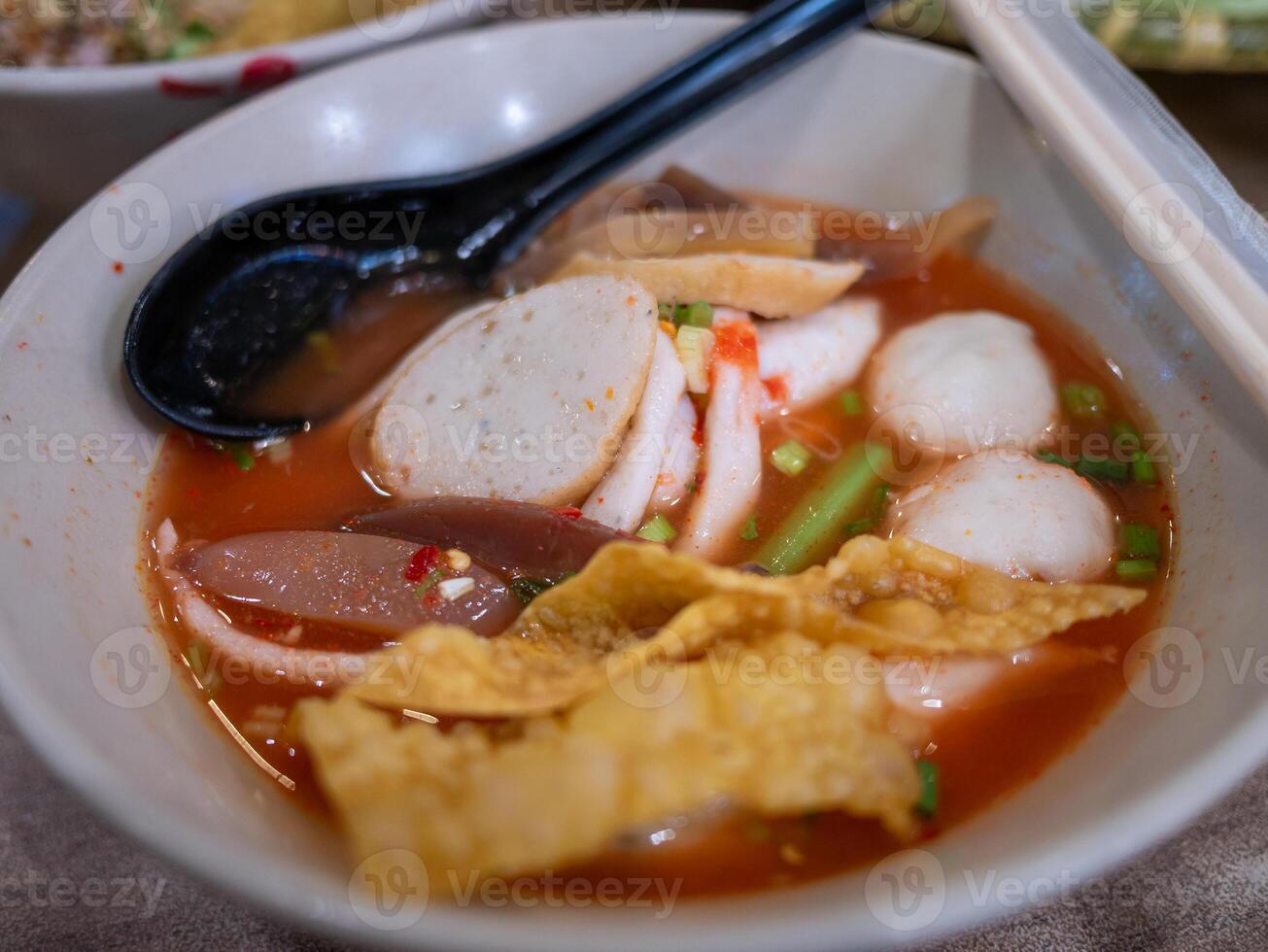 Delicious spicy noodle soup local restaurant food vibrant setting close-up view culinary delight photo