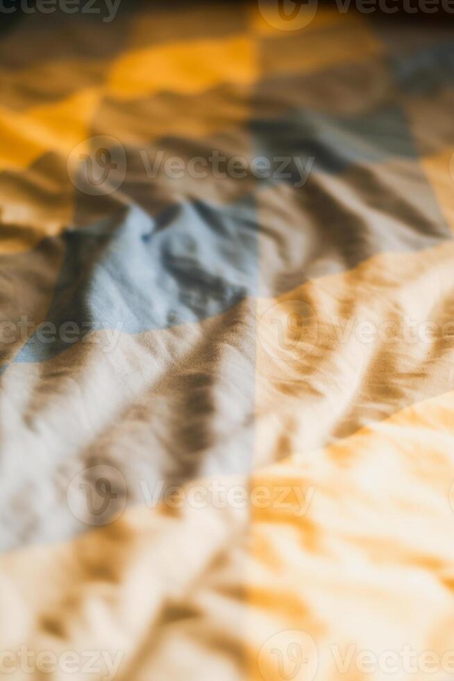 Morning light casting shadows crumpled bed sheets bedroom cozy atmosphere close-up serenity photo