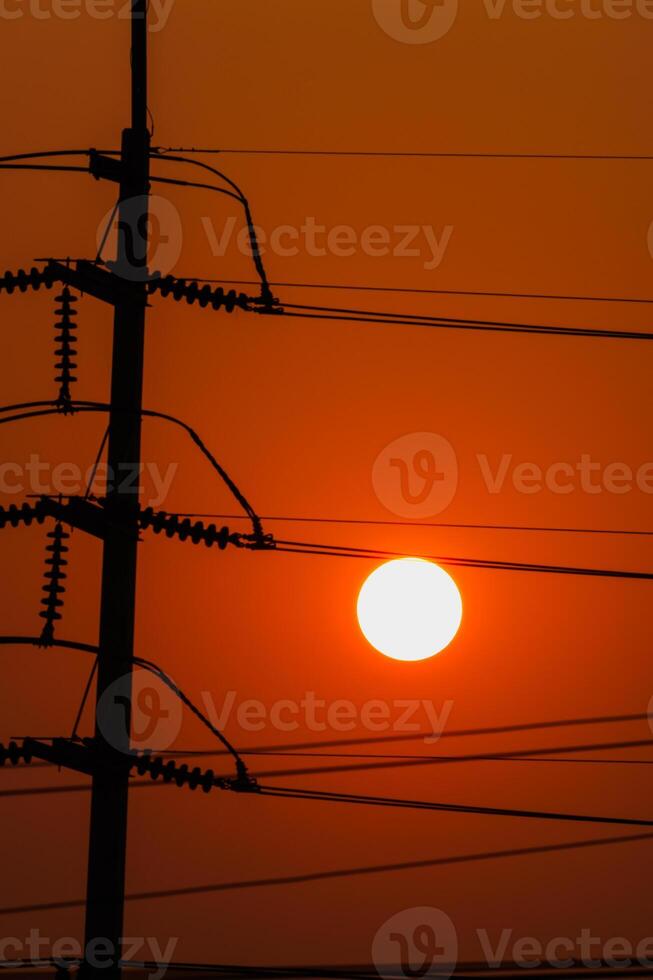 Sunset silhouettes over power lines urban landscape evening glow photo