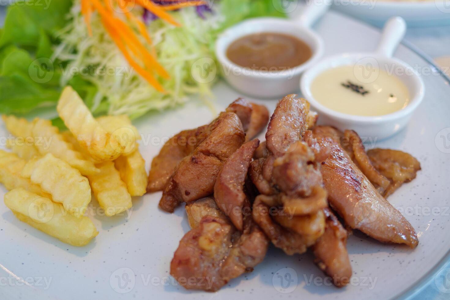 Gourmet experience delicious grilled chicken with fresh salad in a restaurant setting photo