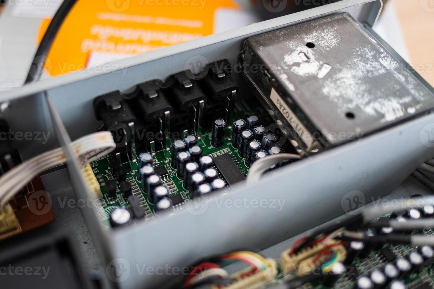 Examining circuit board components in a technology workshop close-up view industrial environment photo