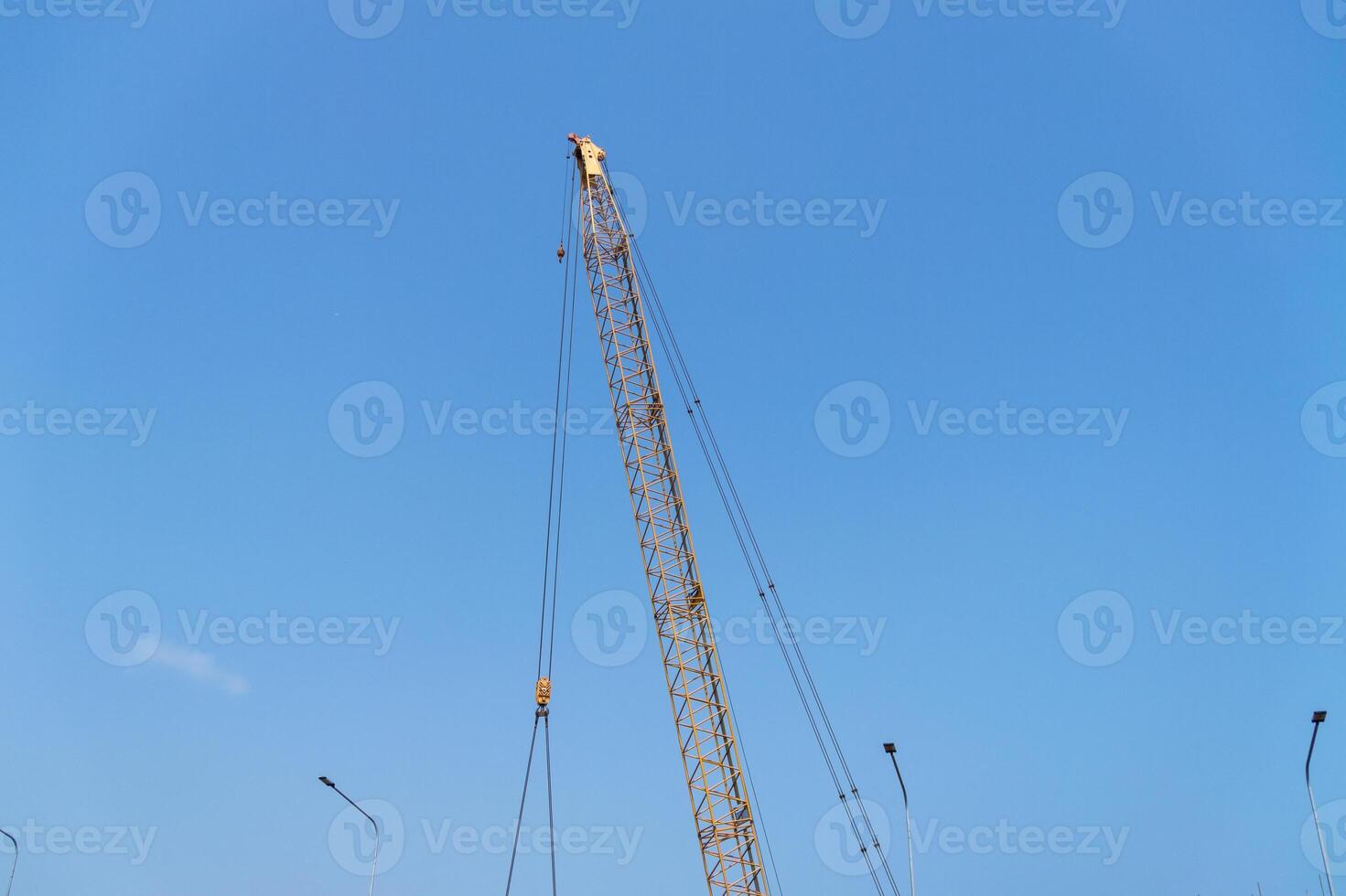 Industrial aerial view construction crane at building site under blue sky photo