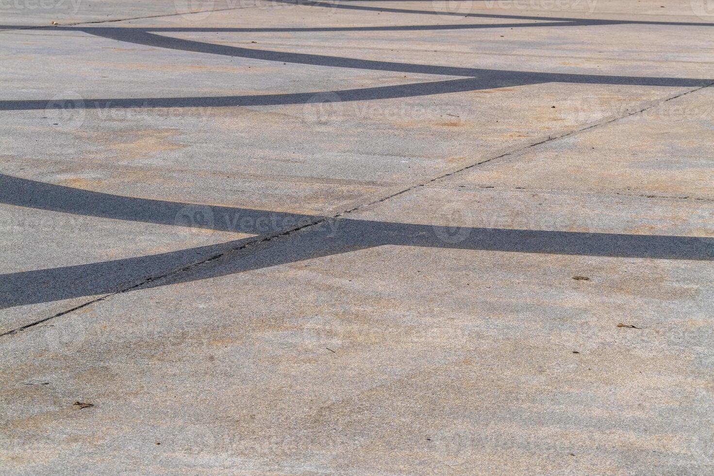 Smooth curves urban concrete pavement city streets artistic shadows daylight abstract patterns photo