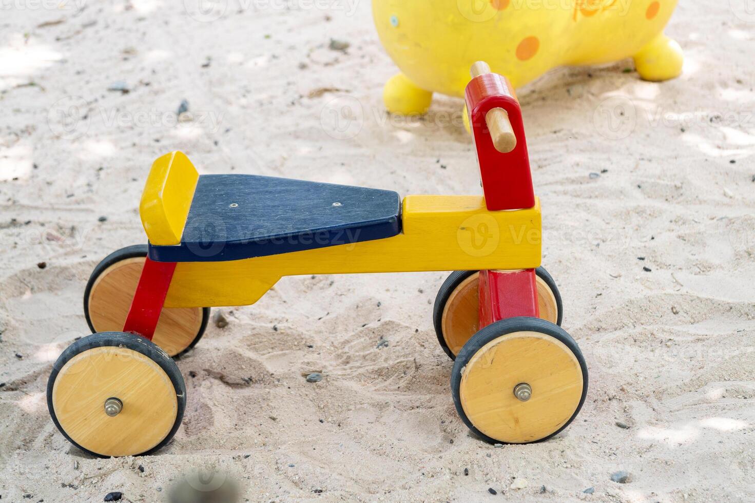 Playful wooden toy vehicle for fun beach playground exploration in sunny environments photo