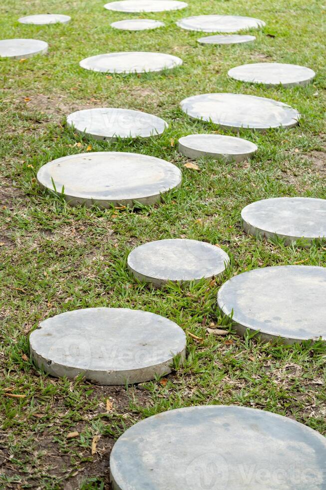 Pathway of circular stones grass outdoor garden nature serene environment low angle view photo