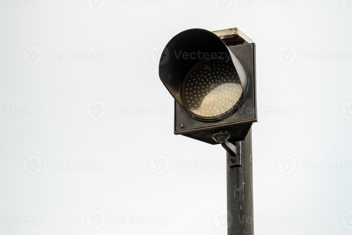Daylight close-up of traffic light signal at urban intersection for vehicle safety alert photo