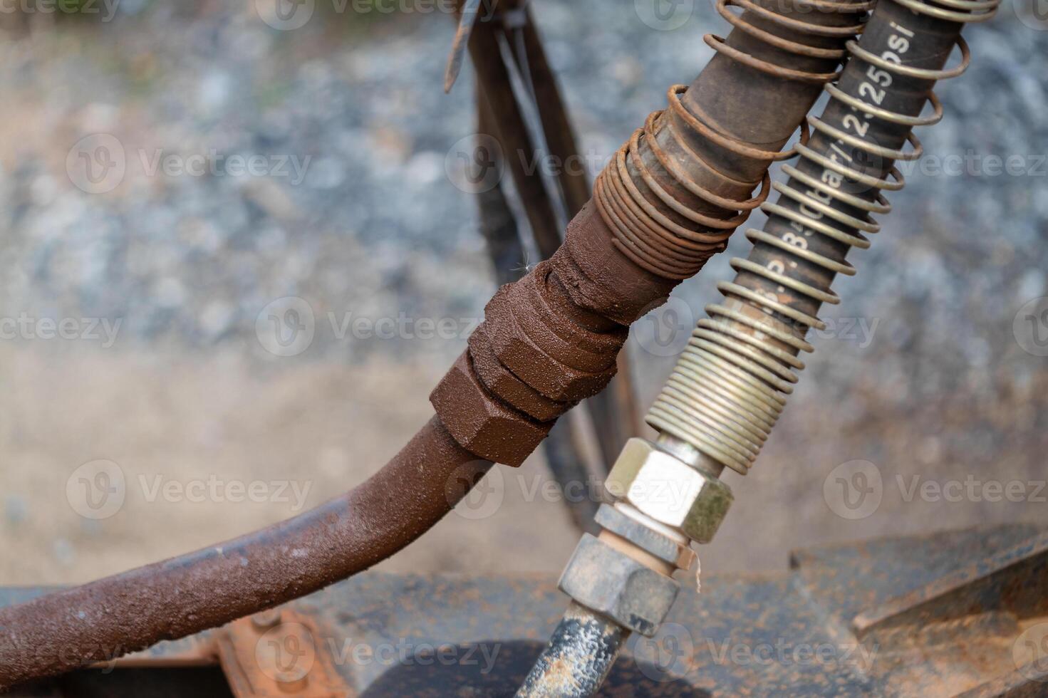 Industrial equipment maintenance hydraulic hose connection workshop close-up mechanical system photo