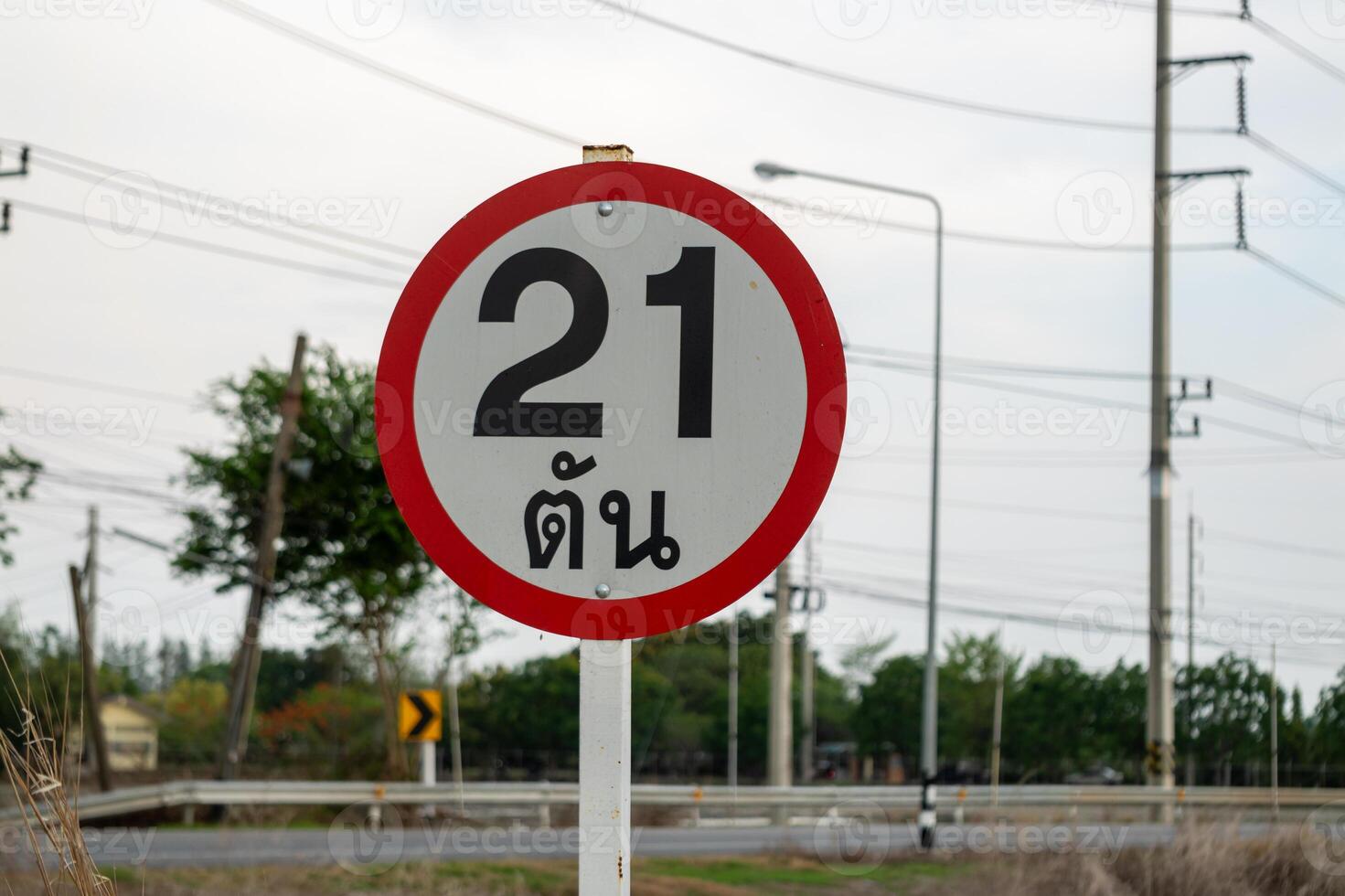 Navigation in rural areas 21 km distance signage at ground level in open environment photo