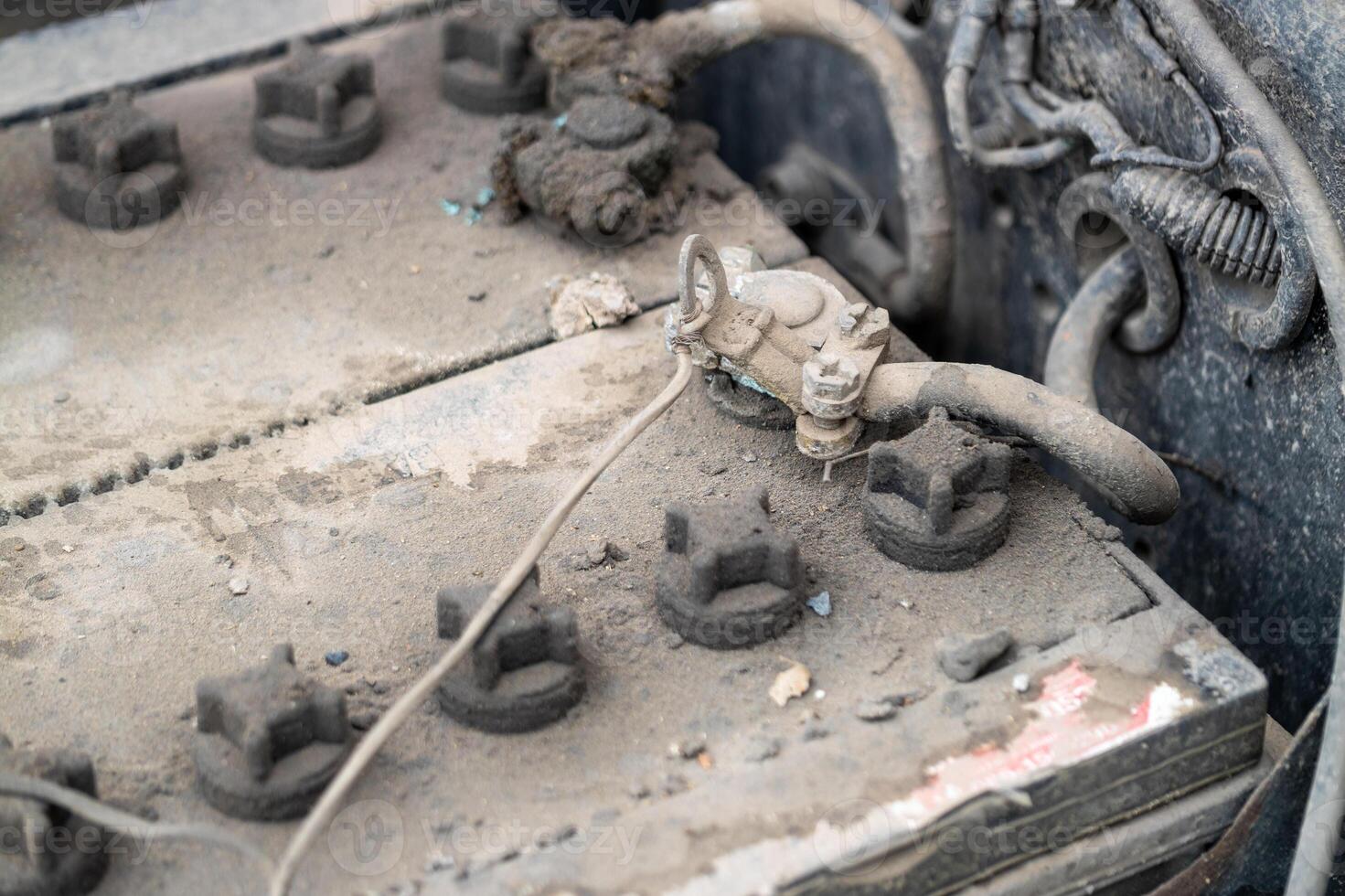 Inspecting a dusty vehicle battery garage workshop industrial setting close-up maintenance insight photo