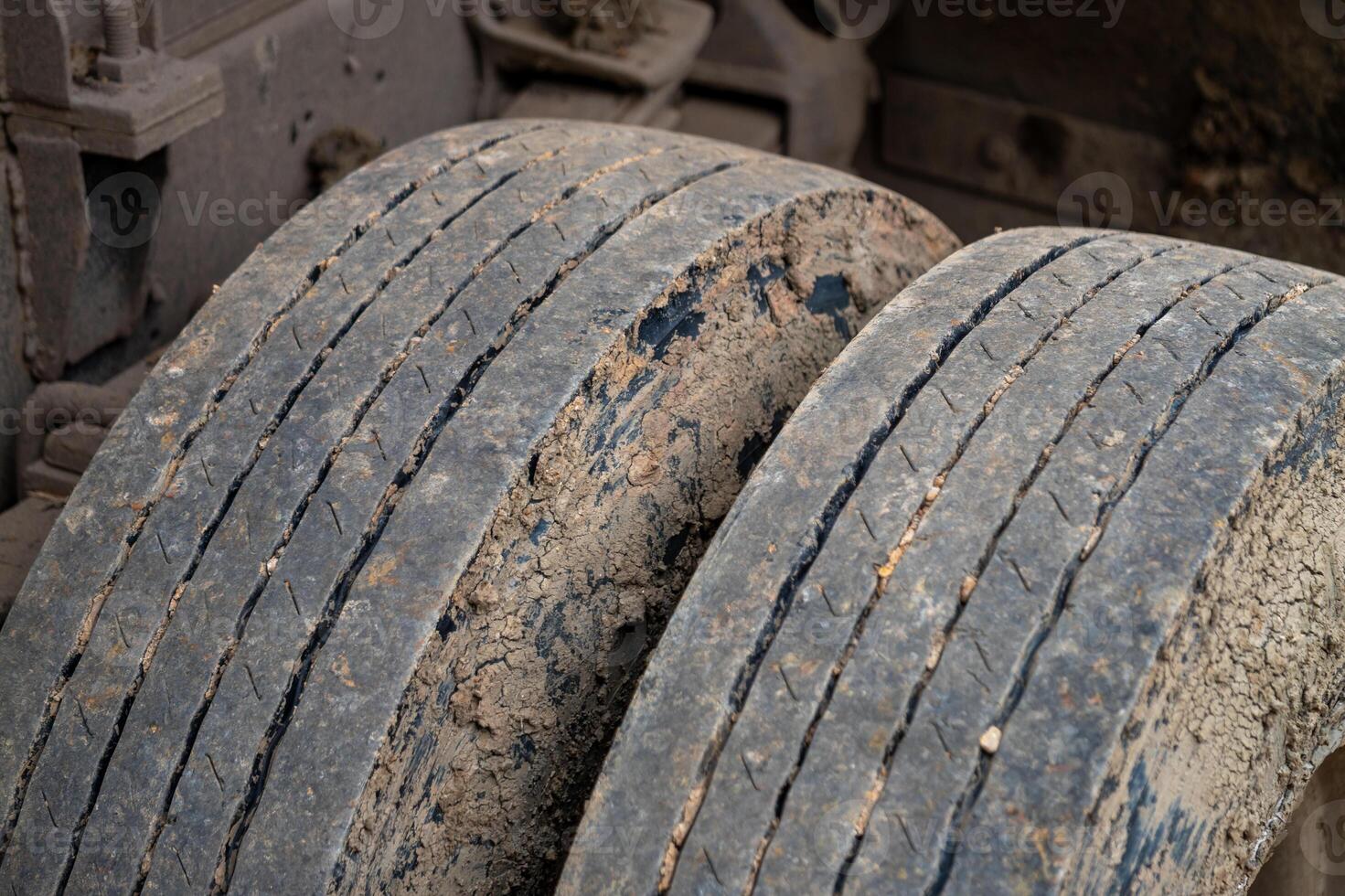 Inspecting worn tires heavy machinery in industrial setting close-up view maintenance concept photo