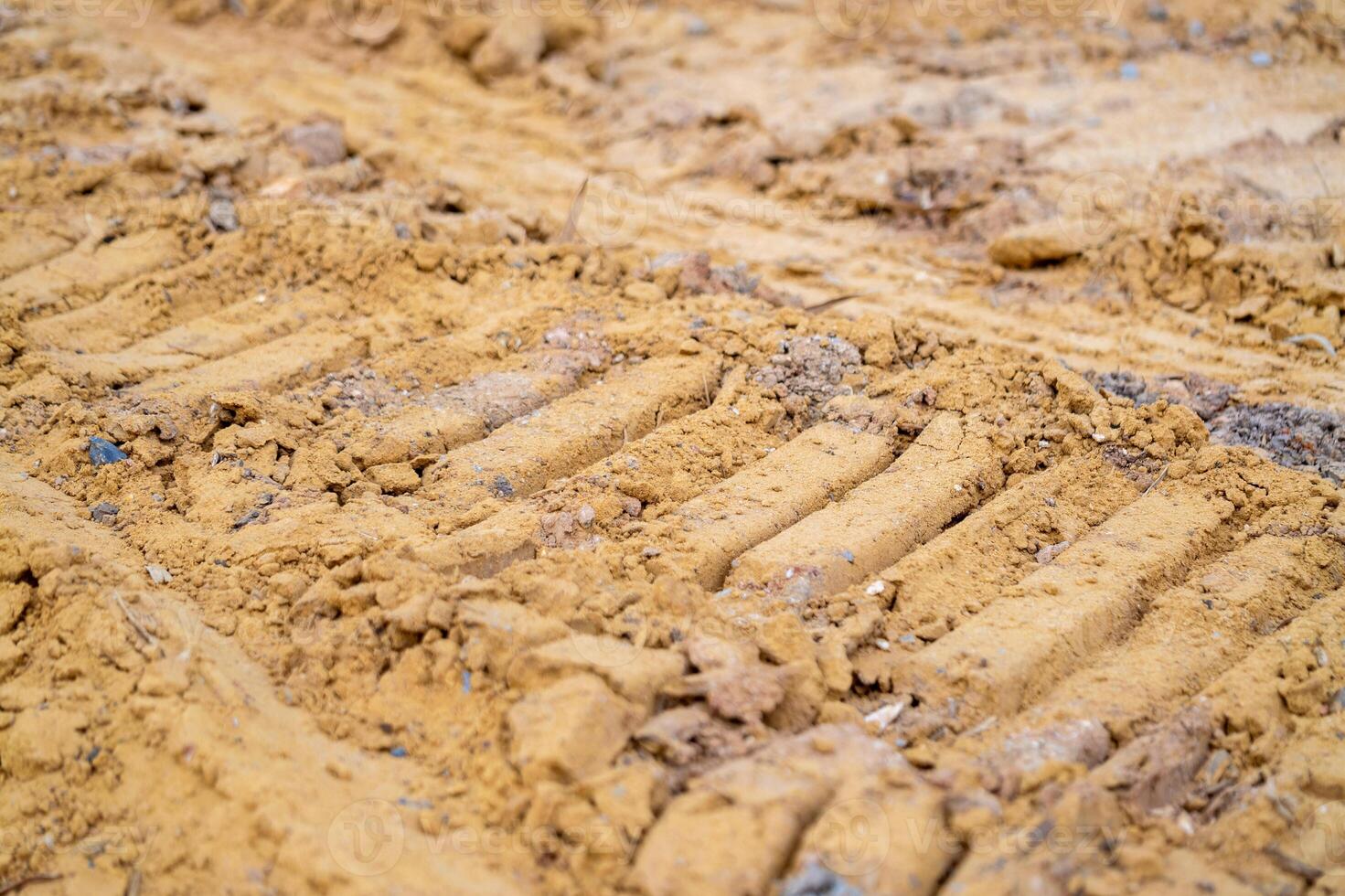 Construction action tire tracks sandy soil outdoor site close-up view industrial context photo