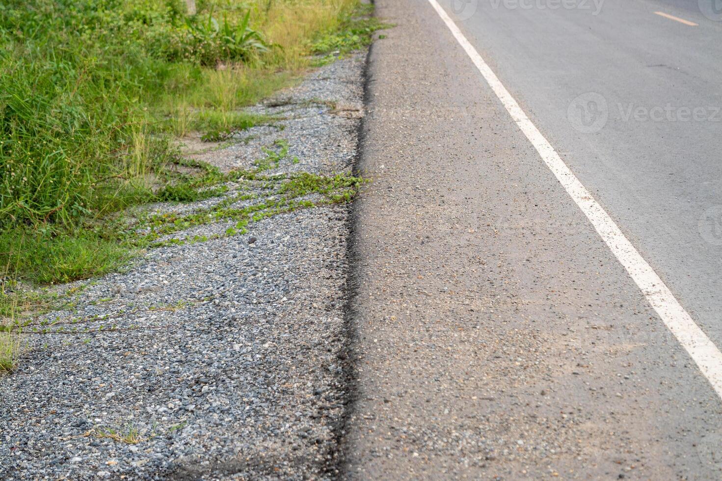 Roadside nature scene with gravel and greenery rural landscape outdoor natural view photo