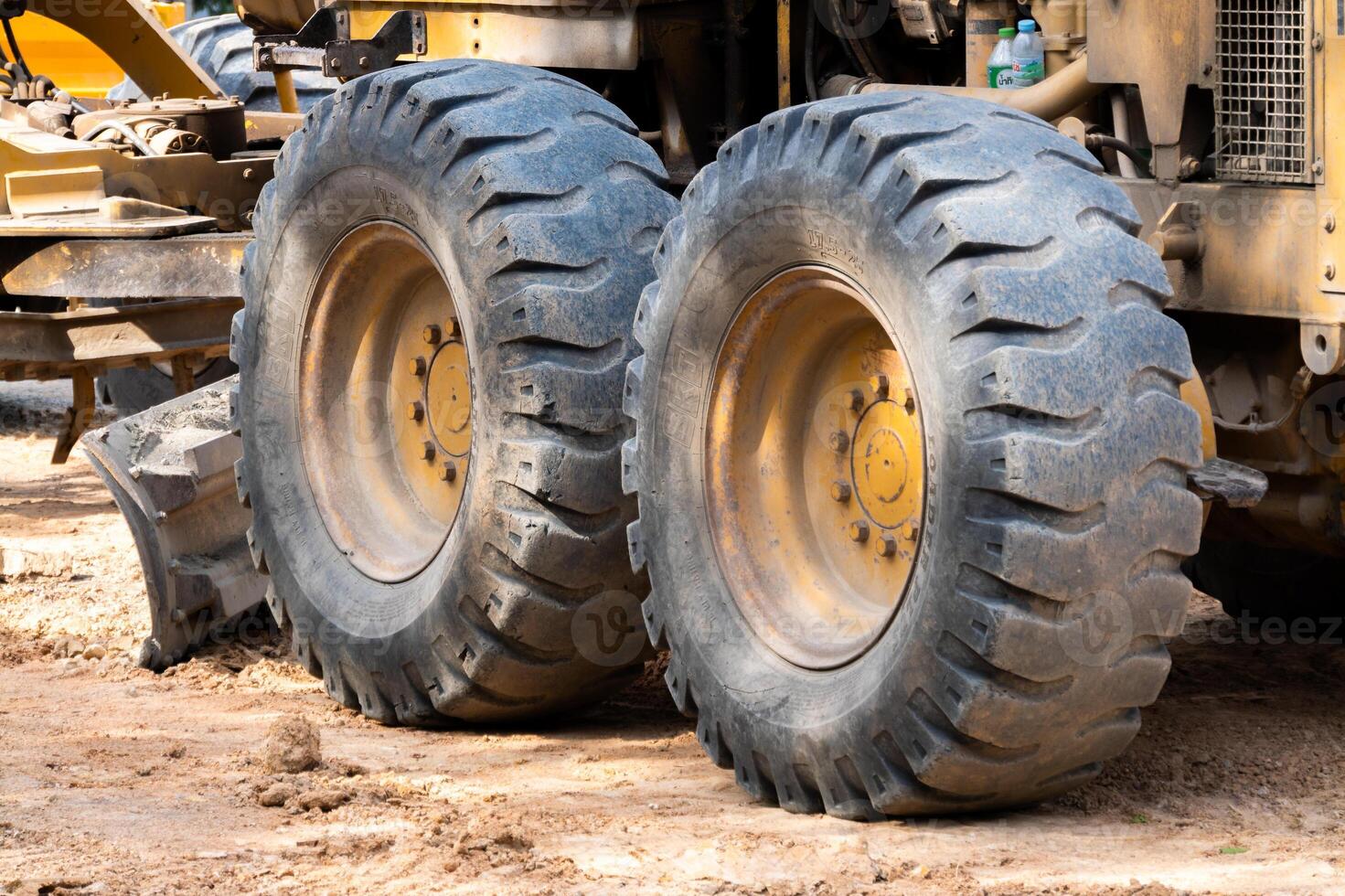 Heavy machinery action construction site detailed tire close-up outdoor ground level industrial insights photo