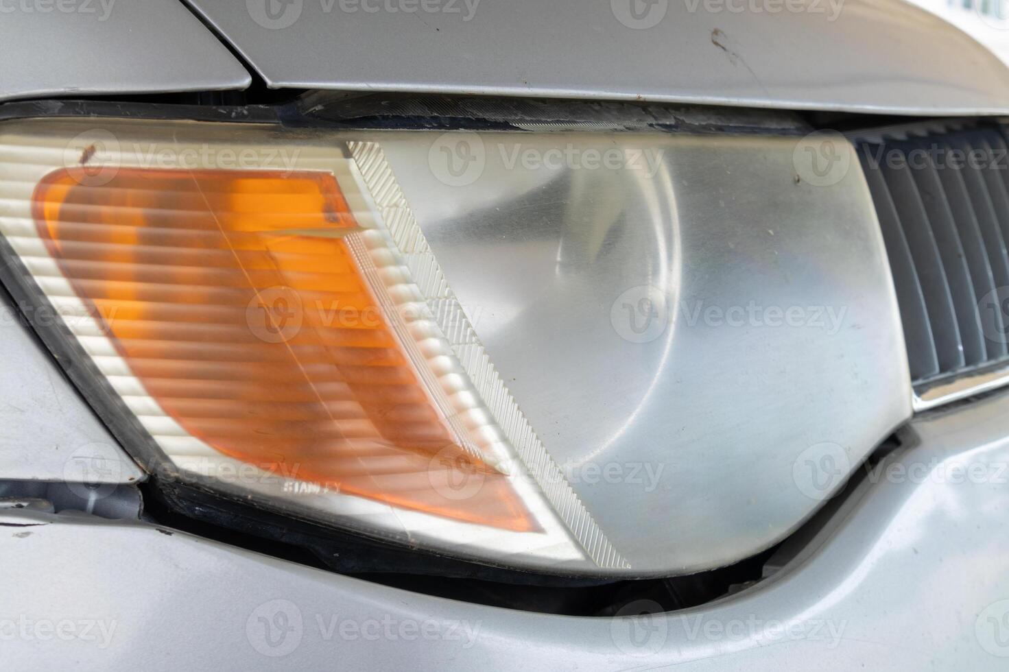 Vehicle headlight detail urban garage close-up high contrast automotive concept photo