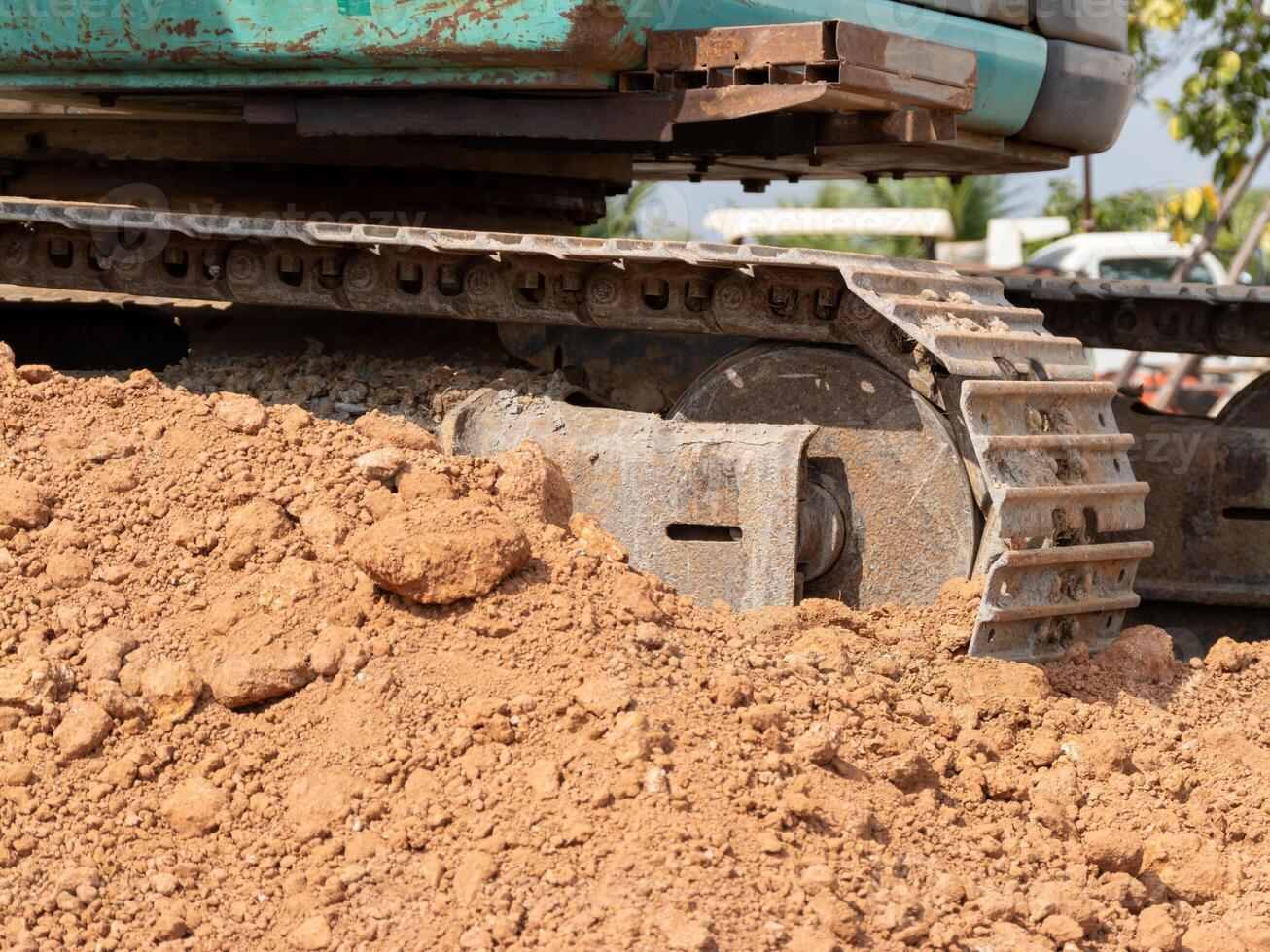 Excavator tracks construction site urban environment heavy machinery close-up view photo