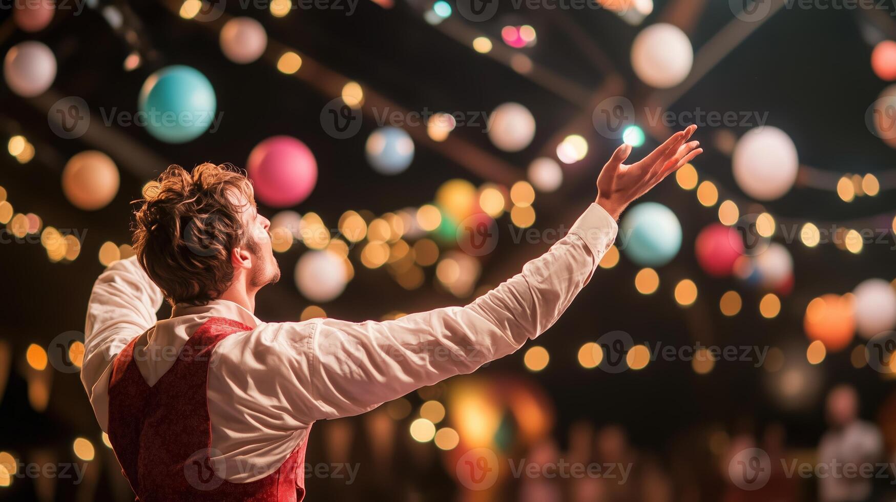 Performer captivating audience at a vibrant outdoor festival with colorful decorations in the evening photo