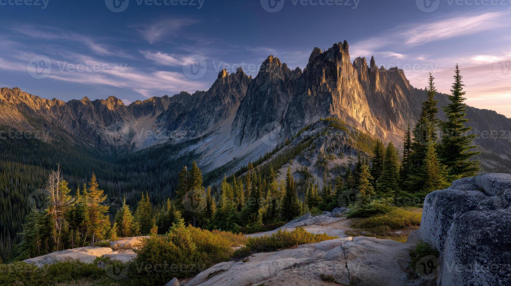 Majestic mountain peaks glow in the warm evening light creating a breathtaking landscape and sense of adventure travel photo