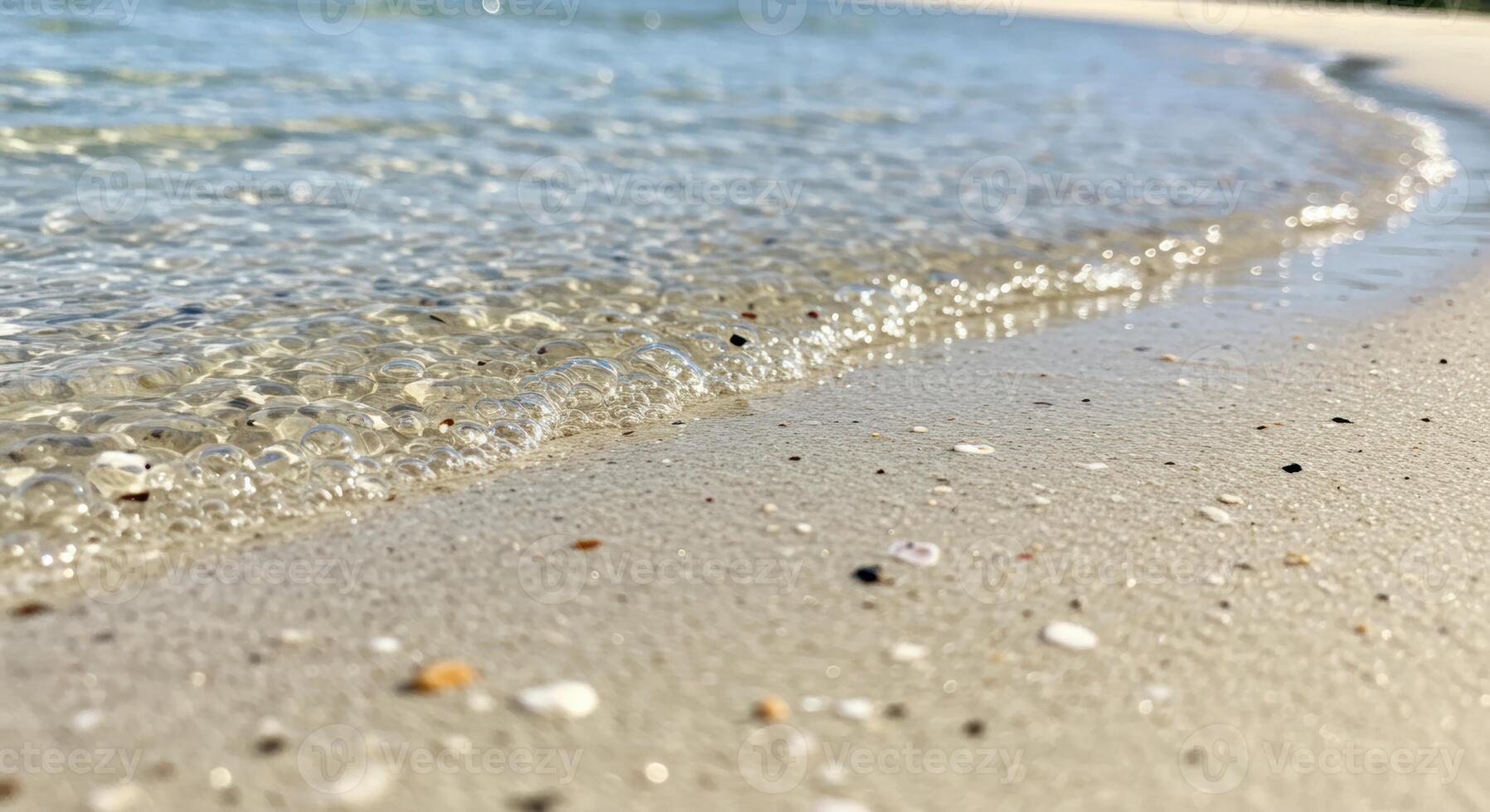 Calm waves meet sandy shore creating tranquil coastal scene with natural textures and beautiful seaside view photo