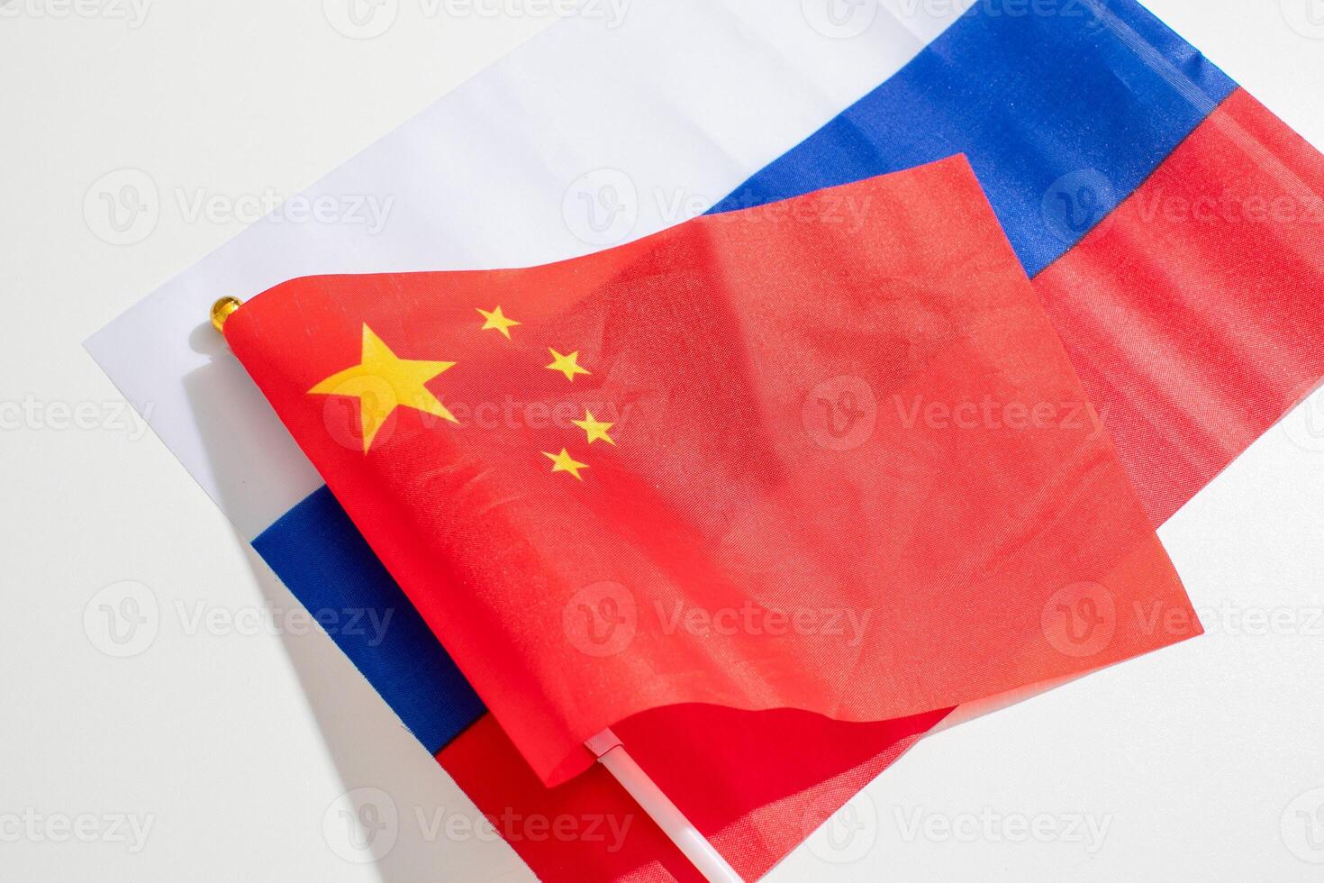 Fluttering juxtaposition of Chinese and Russian flags symbolizes diplomatic ballet, cultural symphony, and unconventional Unity Day reflections photo