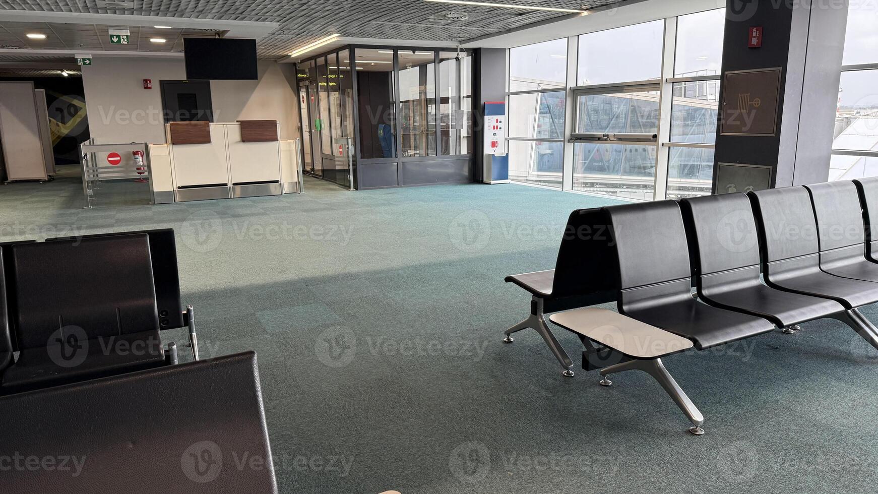 Empty airport gate lounge exudes serene anticipation, embracing transient moments of wanderlust and solitude, celebrating World Aviation Day photo