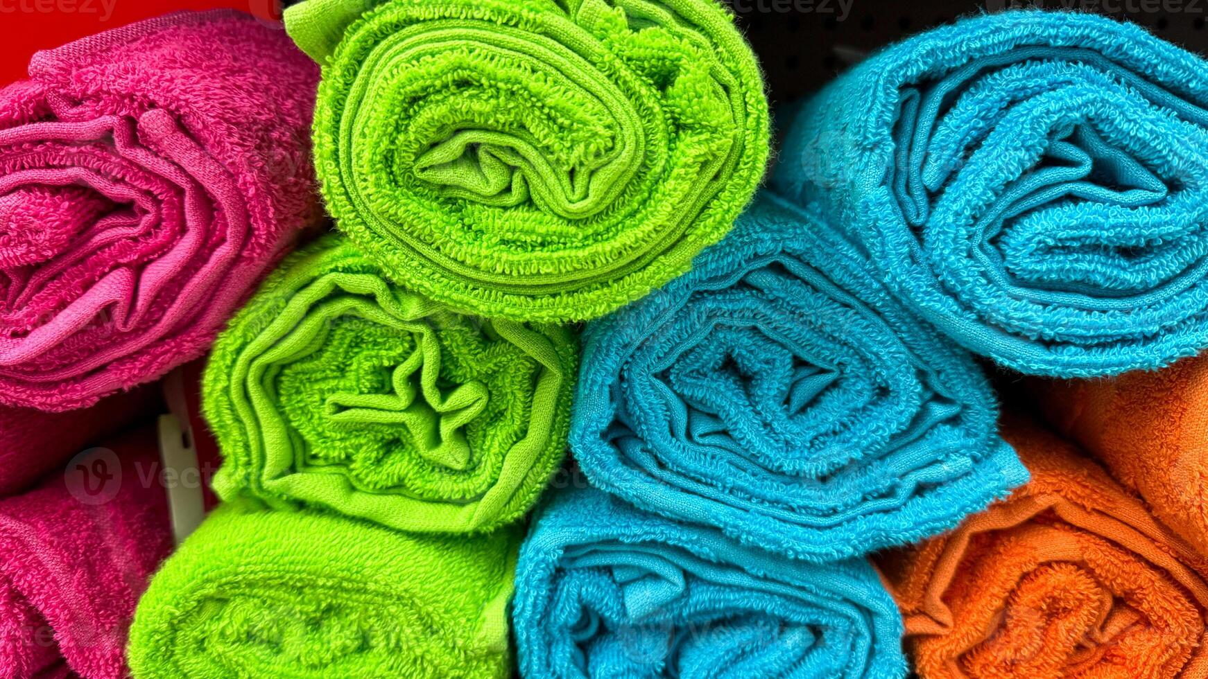 Vibrantly rolled rainbow towels stacked like candy, echoing Holis festive riot, igniting textile rejuvenation and chromatic mindfulness photo