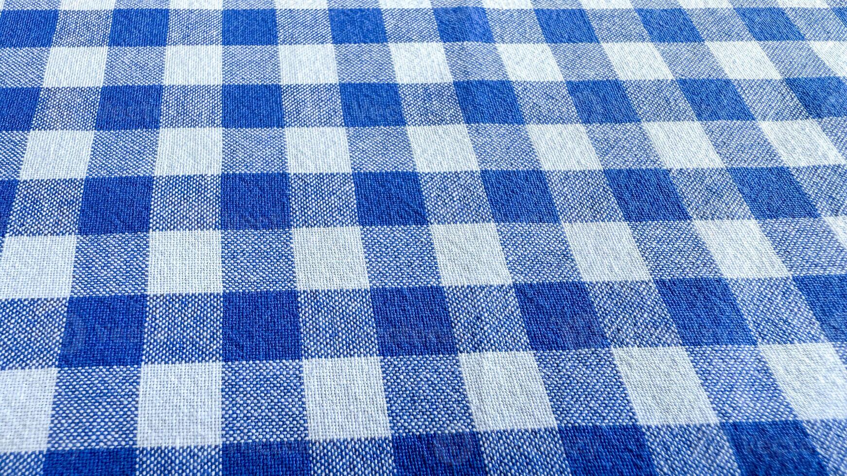 Blue gingham tablecloth celebrating Picnic Day evokes rustic charm, perfect for Bastille Day feasts or family reunions photo