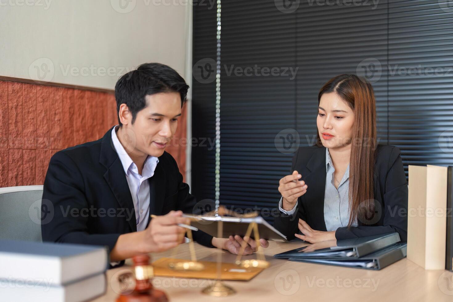 Legal Advice and Professional Interaction. A lawyer showing legal documents to a client in a modern office. photo