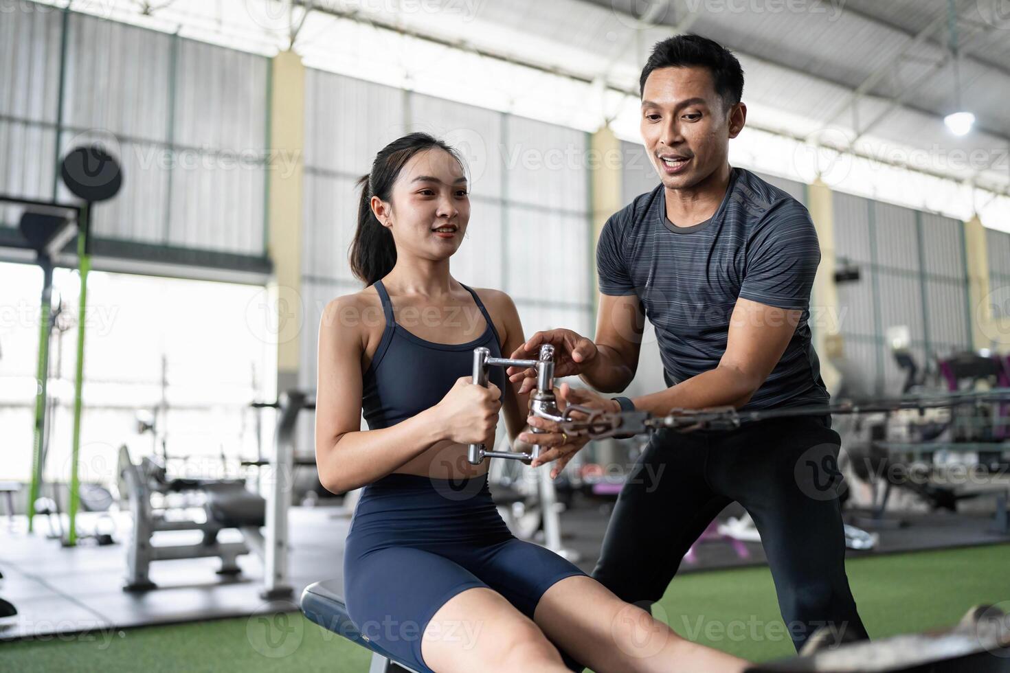 Personal Trainer Demonstrating Rowing Technique to Client photo