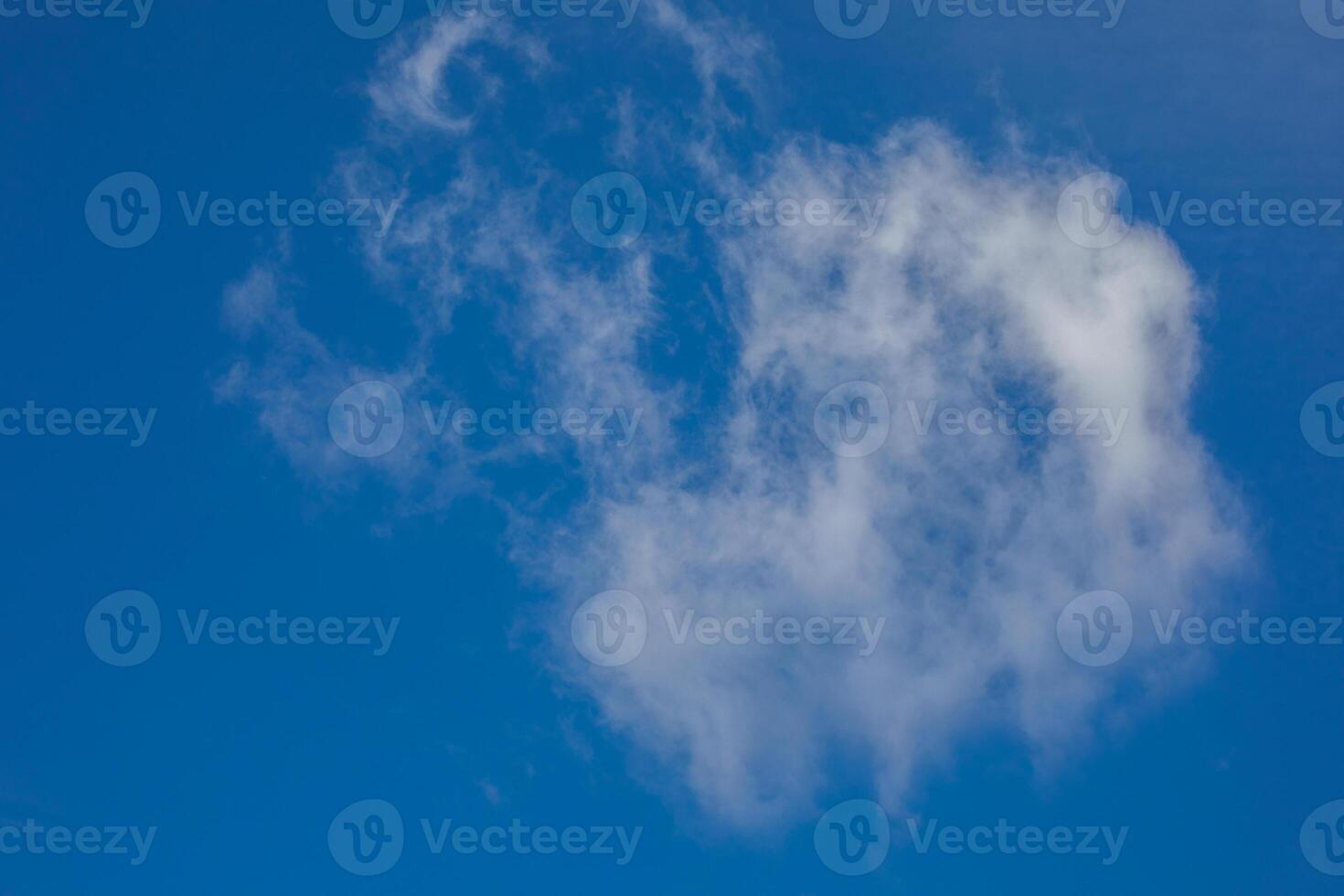 Fluffy cloud whispering cryptic tales in cobalt sky, reminiscent of Dream Day contemplation and World Cloud Appreciation photo