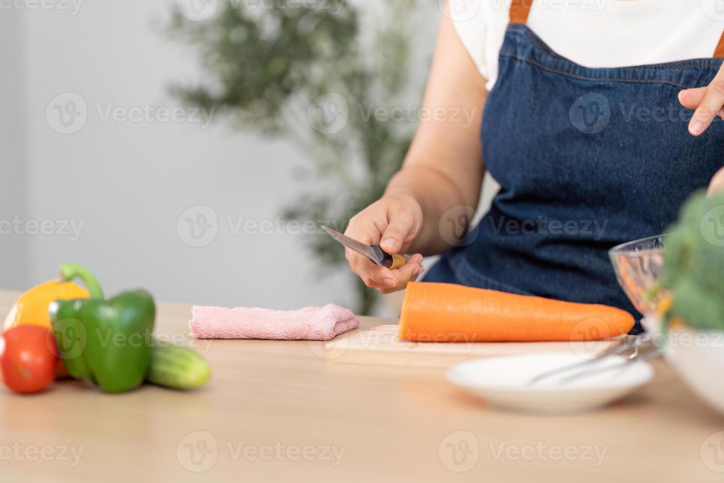 Healthy Cooking and Meal Prep. A person chopping fresh vegetables in a modern kitchen. photo