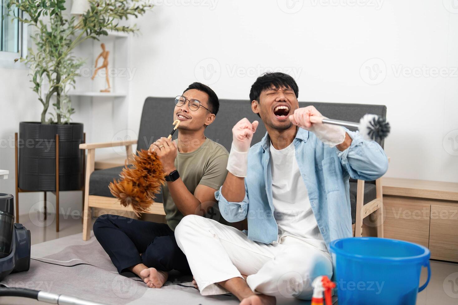 LGBTQIA Partners Singing While Cleaning Their Home photo