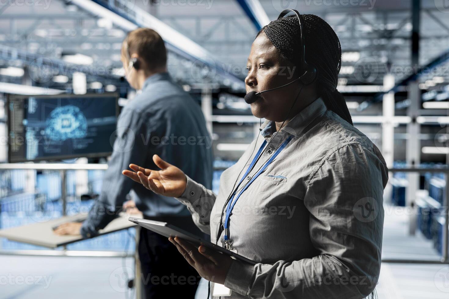 Team of data center experts delivering comprehensive user support and issue resolution using AI. Server farm colleagues diagnosing customers issues through support tools and headset mic photo