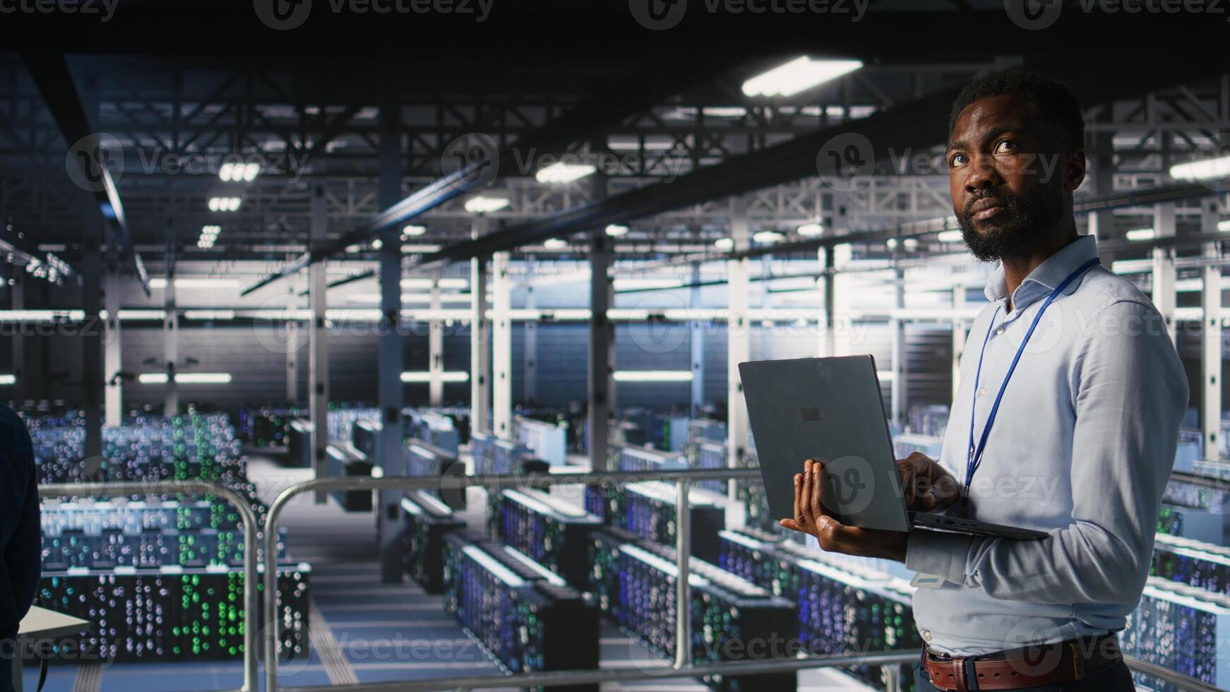 Engineers in data center using laptop to monitor neural network LLM visualization. Coworkers on server hub industrial platform overseeing server clusters powering machine learning processes, photo