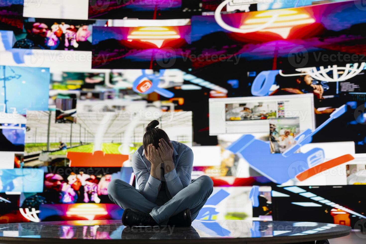Young man stares at smartphone in distress symbolizing toxic impact of social media on mental health. Likes, posts and endless scrolling lead to stress, anxiety and depression. Overwhelmed user. photo
