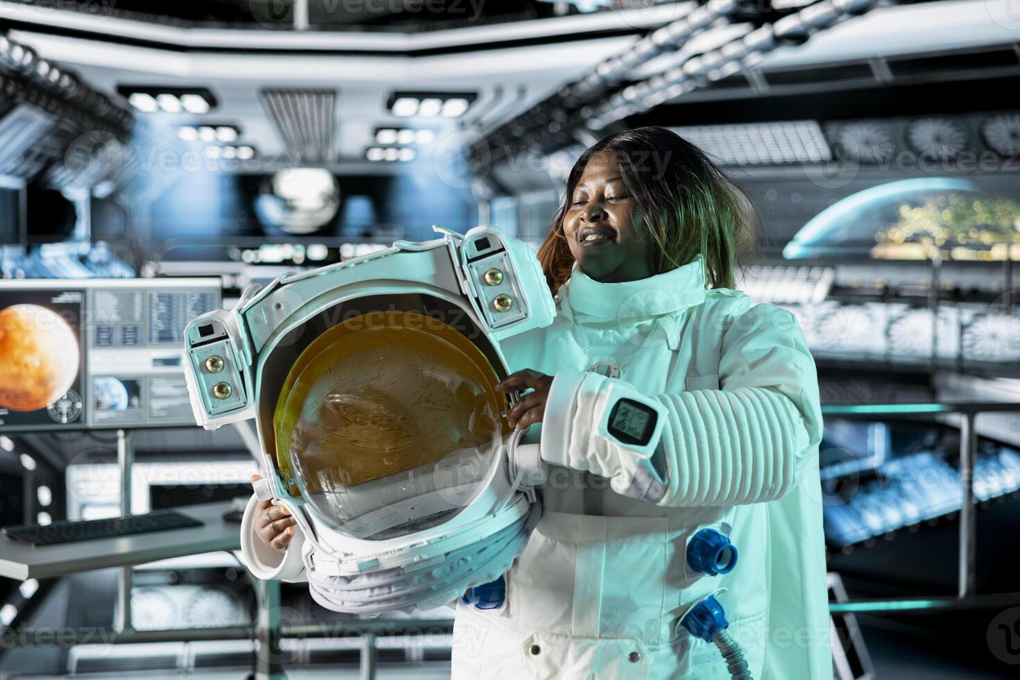 Astronaut holds helmet inside space station, preparing for mission outside, on hostile planetary habitat. Starship crew member beginning landing procedures on extraterrestrial planet photo