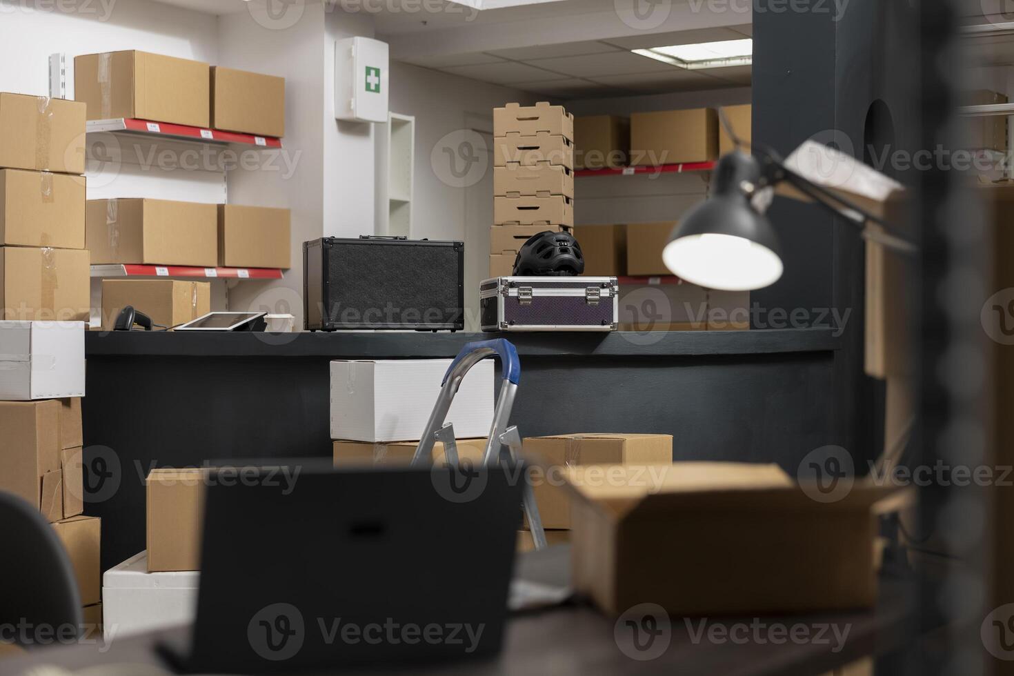 Empty depot storage room in distribution center shows workspace prepared for order processing and product handling in a local warehouse. Hand packing tasks in an inventory room. photo