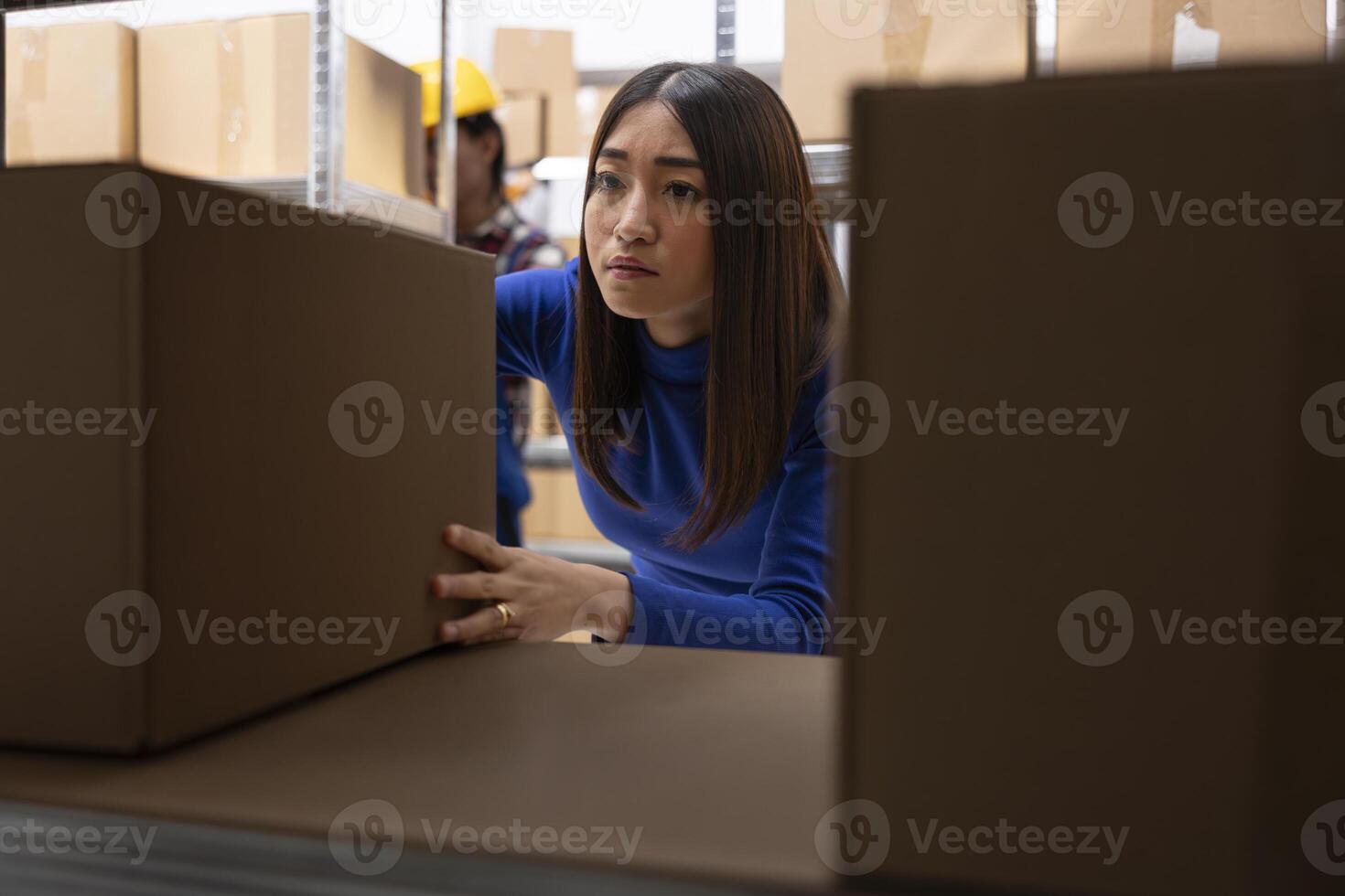 Asian woman preparing custom orders in storage room with parcels and products. Local shipping and retail fulfillment are part of daily business operations in small scale logistics center. photo