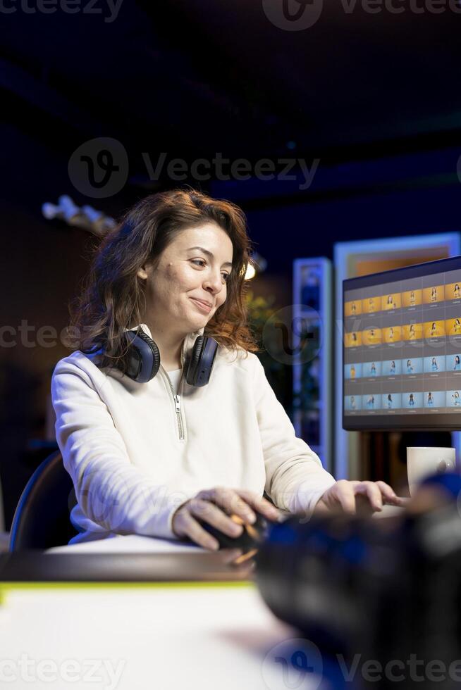 Upbeat photographer using professional photo editing tools on PC. Joyous photo editor utilizing high tech photographs retouching application to make adjustments on computer screen