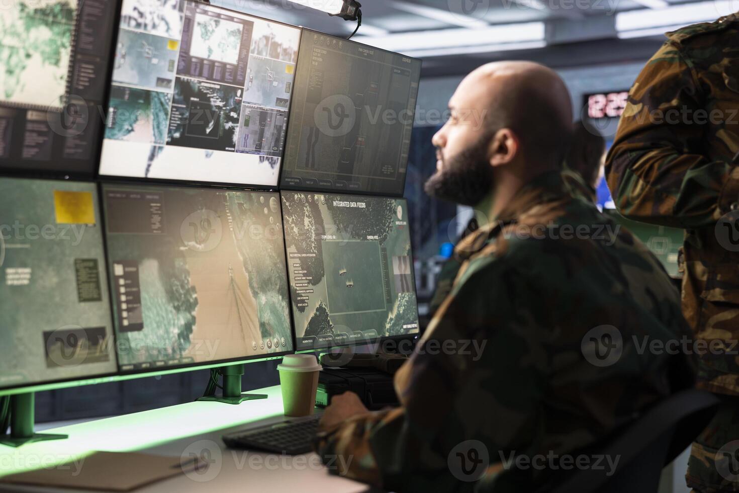 Military agent working in control room, analyzing aerial reconnaissance data to come up with warfare winning tactics. Intelligence corps agent controlling drones attacking strategic targets photo