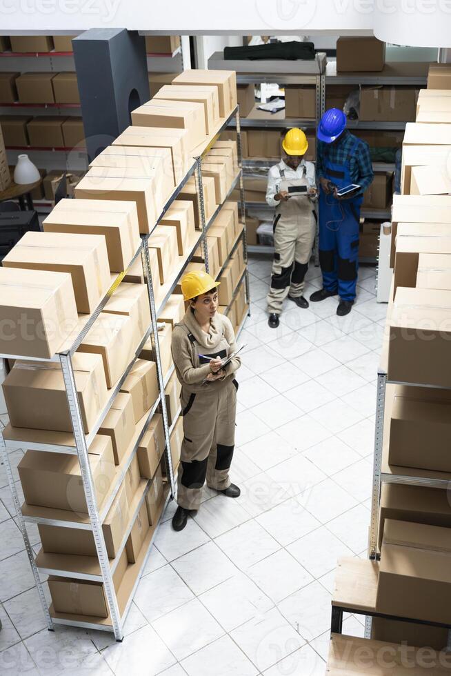 Industrial workspace supporting supply chain process to organize boxes and prepare shipments for dispatch in a highly functional logistics center. Quality control in cargo depot. photo