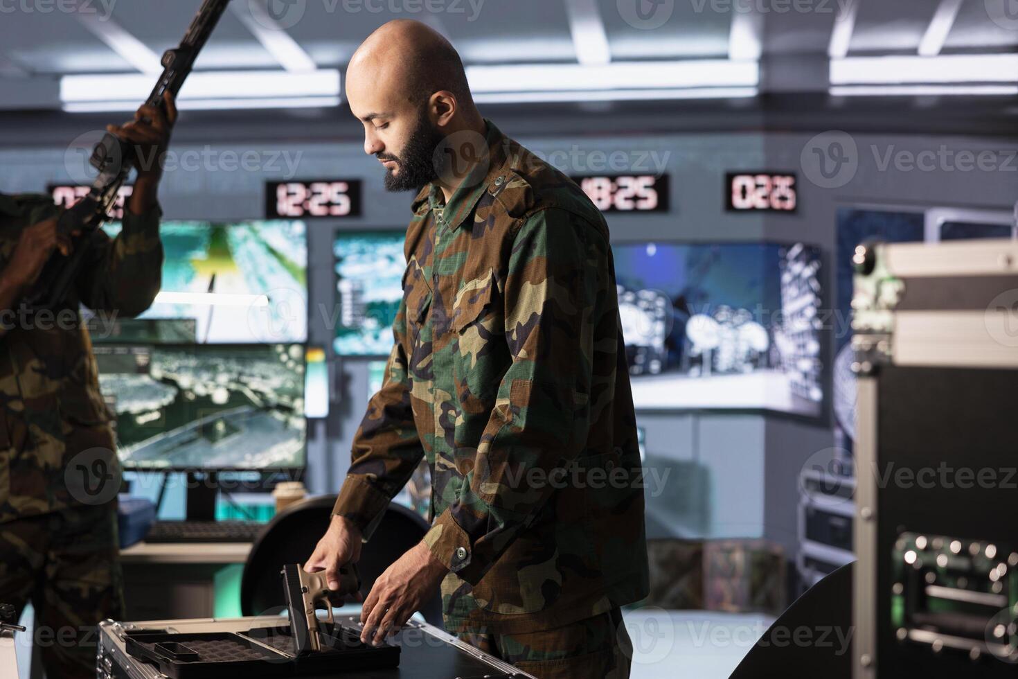 Operatives conducing anti terrorism mission, loading weapons, preparing to track enemy forces threatening national security. Army soldiers packing guns, preparing to start assault mission photo