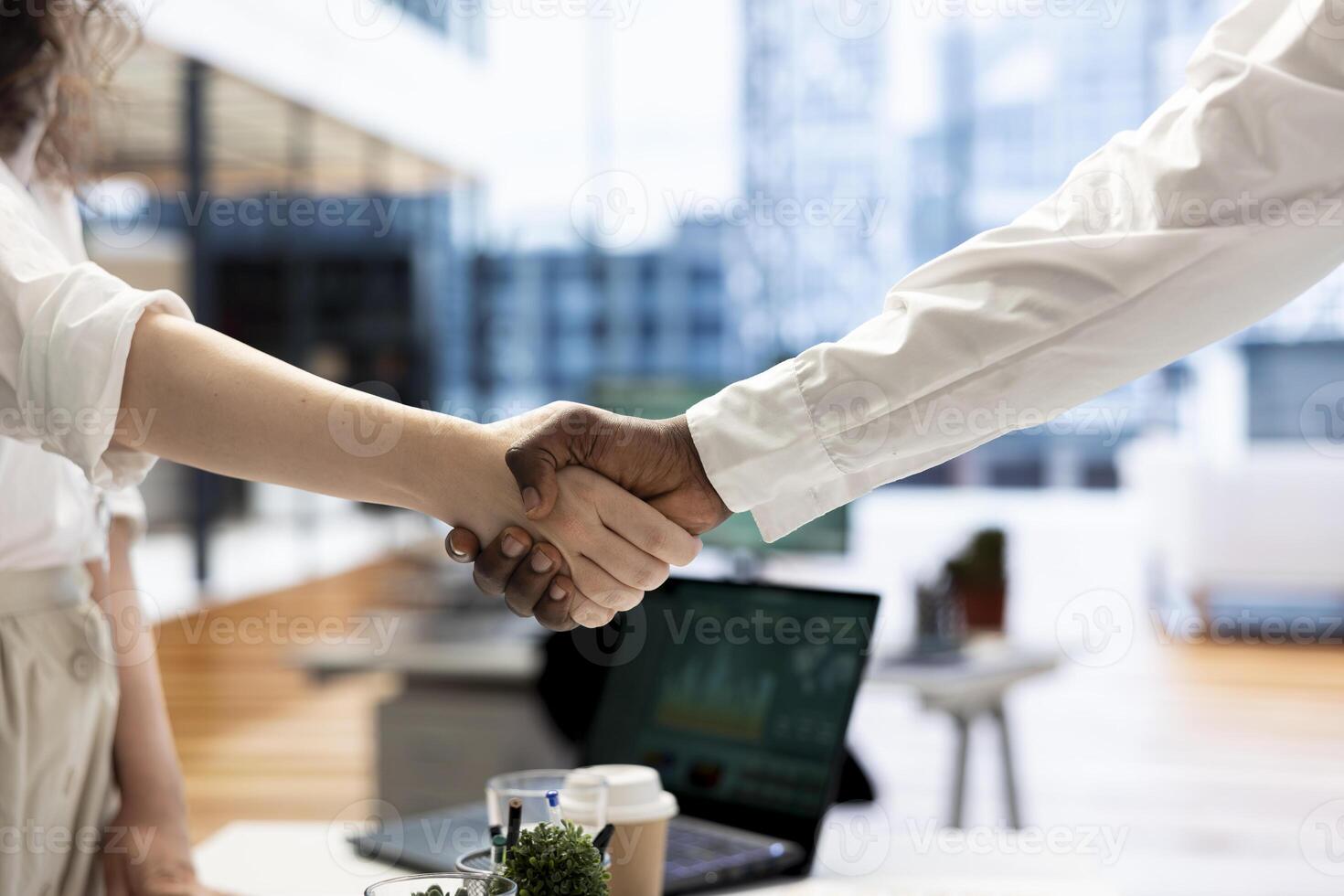 Businessmen in office shaking hands after finishing lucrative financial agreement for company. Close up of manager meeting with man, doing welcoming handshake gesture before starting conversation photo