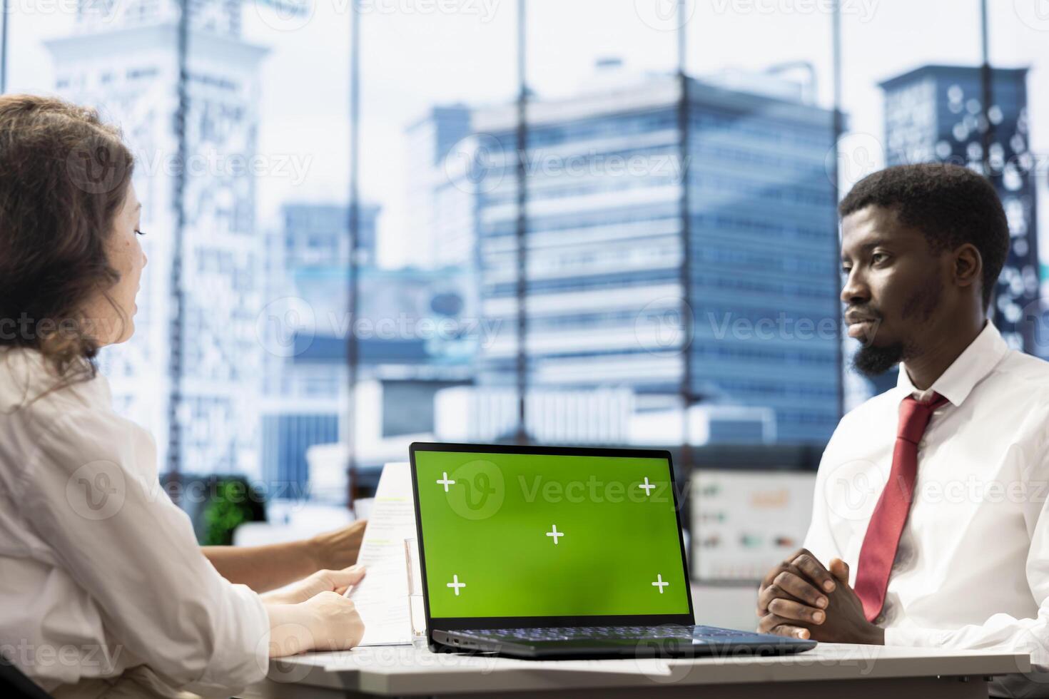 HR worker implementing diversity recruitment strategy for company, using green screen laptop. Recruiter reaching agreement with african american man, using mockup notebook photo