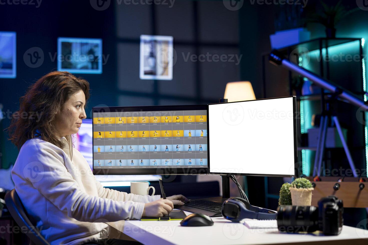 Photographer uses photo editing software on isolated screen PC display in studio. Freelancer uses photographs retouching program on mockup computer monitor, making adjustment with graphic tablet