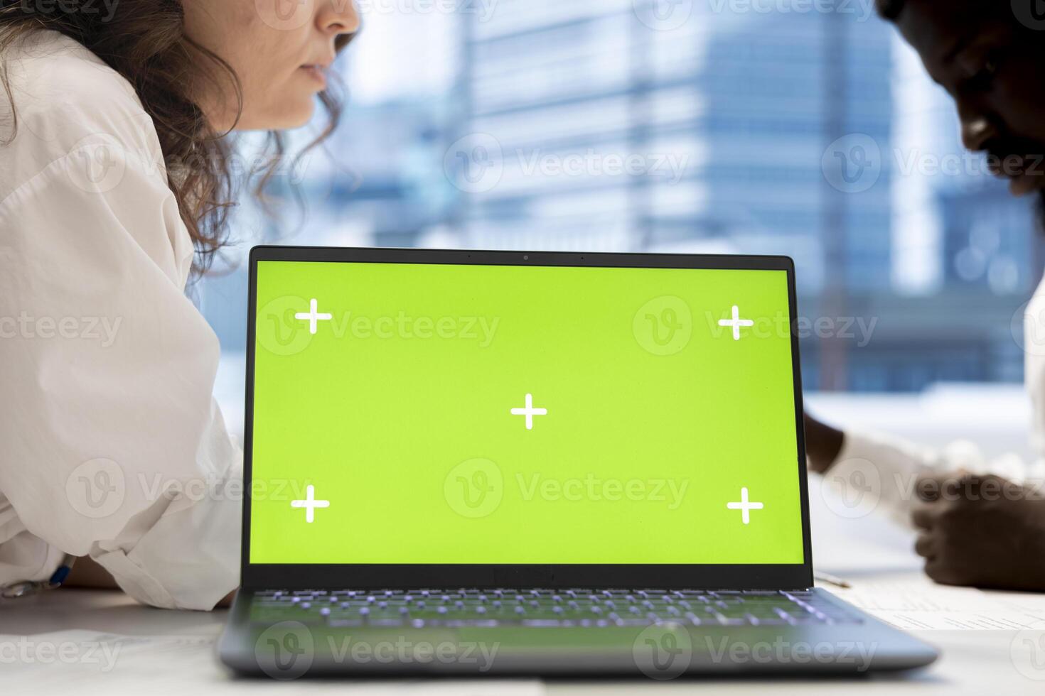 HR coworkers using green screen laptop to do preemployment assessments and background checks to potential job applicants. Headhunters use chroma key notebook to attract qualified candidates photo