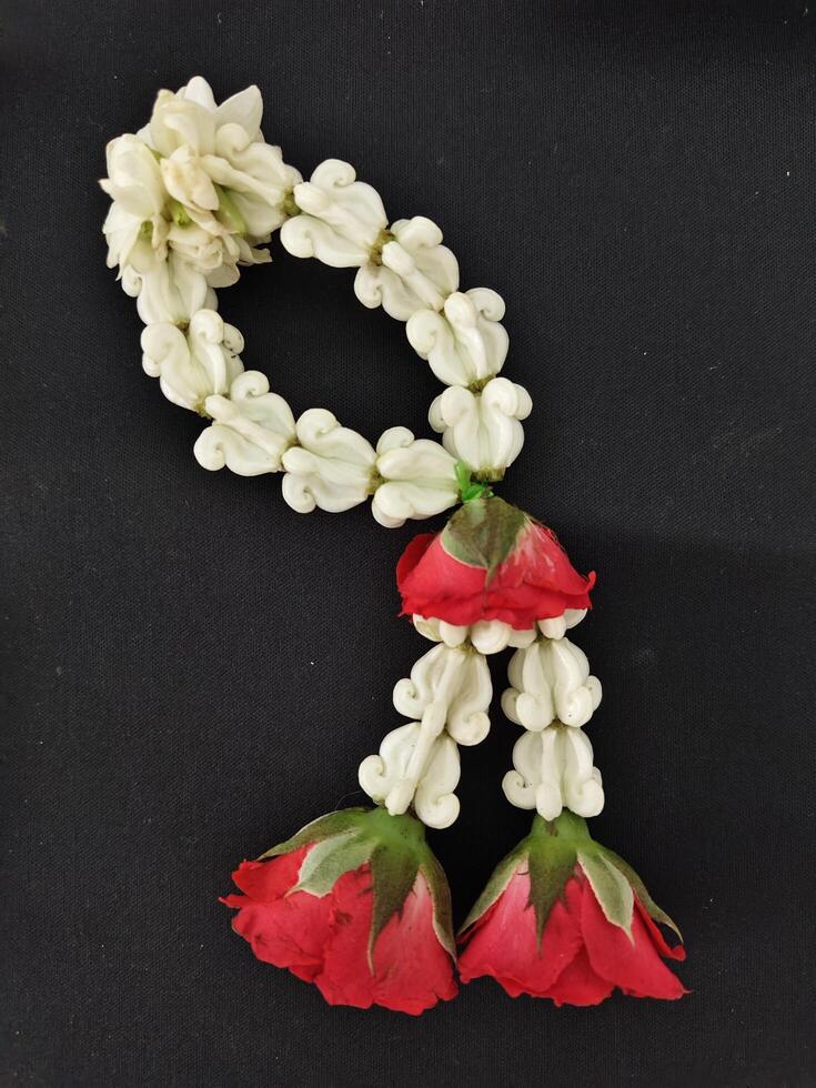 Thai form of floral garland on black background. photo