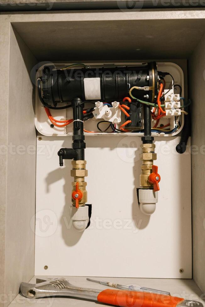 Indoor heating system maintenance with tools and pipes photo