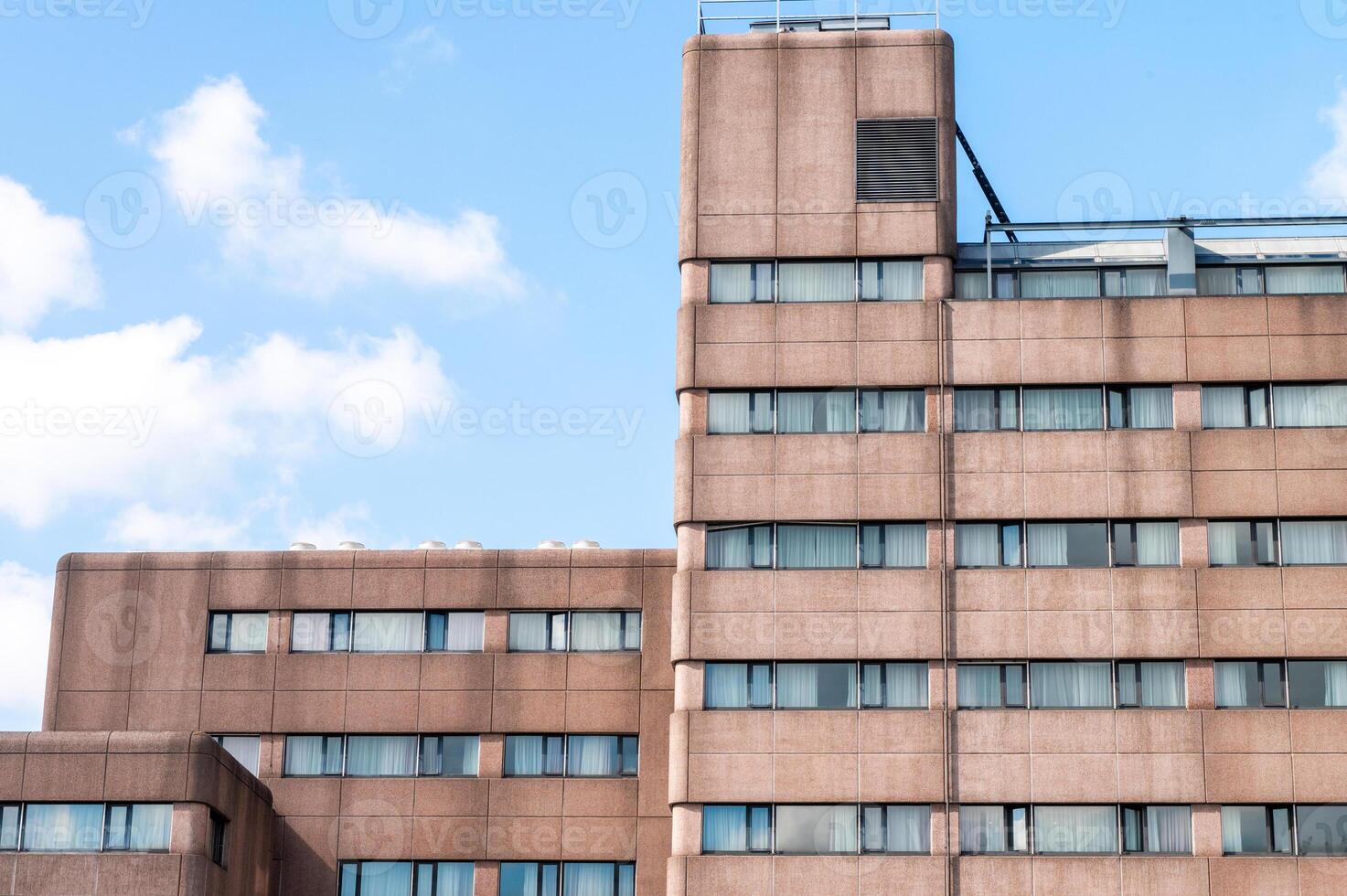Urban architecture of a modern high-rise building against a clear sky photo